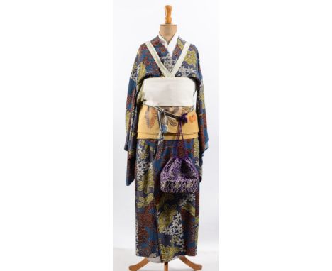 An early 20th century Japanese kimono, on a period mannequin, together with a pair of Japanese shoes, and a pair of child's s
