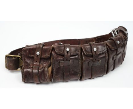 A Boer War period leather bandolier:, with 5 strap and button cartridge pouches, brass strap buckle and steel hanger clip.