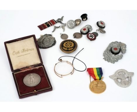 A WWII period German National Socialist party enamel badge, together with a collection of Third Reich period cap badges, butt