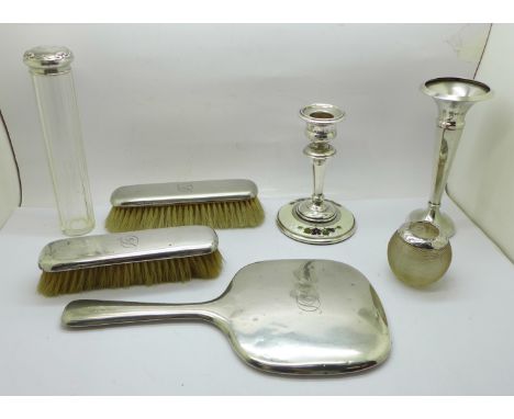 A silver backed mirror and two brushes, a silver vase, Birmingham 1973, a silver and enamel candlestick, a/f, broken at the n