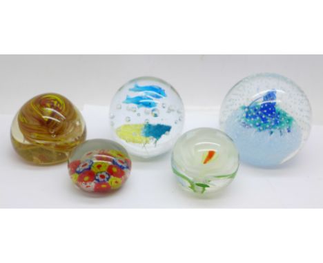 Five glass paperweights including one Caithness 