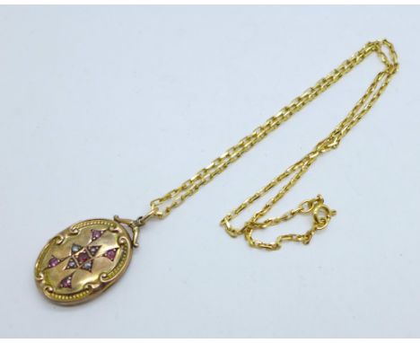 A ruby and pearl set locket on a 9ct gold chain, chain 4.4g and 43cm, locket 20mm x 27mm 