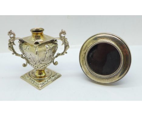 A silver photograph frame, Birmingham 1984 and a Victorian silver table lighter, a/f, London 1895, William Comyns 