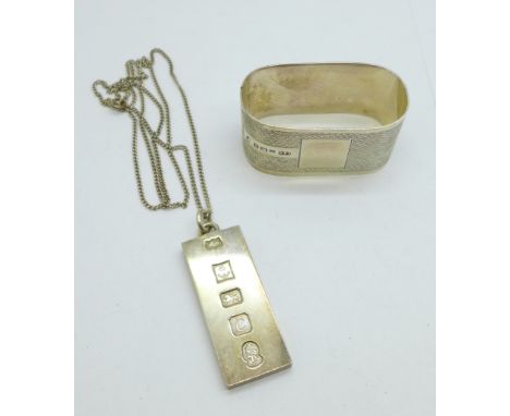 A silver napkin ring and a silver ingot pendant and chain, 56.9g 