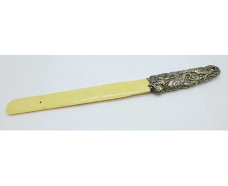 A page turner with white metal handle decorated with a Chinese dragon and with ivory blade 