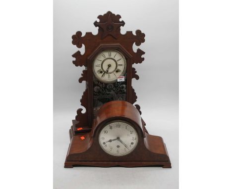 A late 19th century American walnut cased mantel clock, having a painted wooden dial with eight-day movement enclosed by a gl