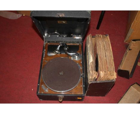 A vintage His Master's Voice portable record player; together with various vintage records