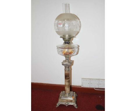 A Victorian style oil lamp, having globular shade above a clear glass font, on a faux marble column with base metal Corinthia