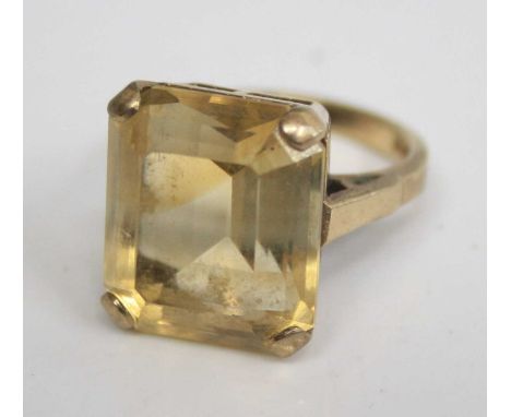 A modern 9ct gold citrine set dress ring, the four-claw set emerald cut citrine measuring approx 15 x 14 x 9mm, 7.3g, size L