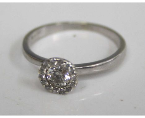 A modern 9ct white gold diamond set dress ring, the centre brilliant weighing approx 0.2 carats within a surround of diamond 