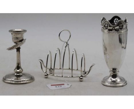 A Victorian silver vase, Birmingham 1852, h.13cm (loaded); together with a silver table candlestick; and a silver toast-rack 