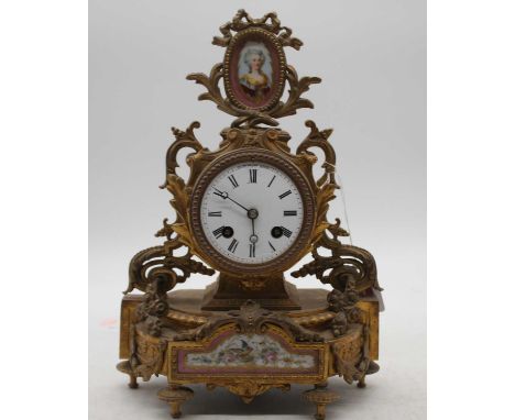 A late 19th  century French gilt metal and porcelain inset mantel clock, having an enamel dial with Roman numerals and eight 