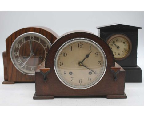 An early 20th century black slate cased mantel clock, having a circular dial with Arabic numerals, cylinder movement, h.22cm;