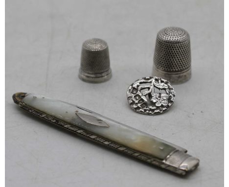 A 19th century fruit knife, having a folding silver blade with mother of pearl handles; together with a sterling silver thimb