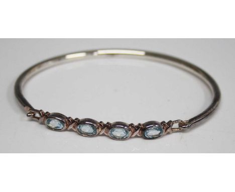 A modern silver and blue stone set bangle 