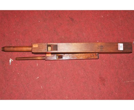 A large vintage stained pine whistle, 60cm; together with one other similar 