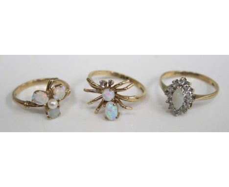 A 9ct gold, opal and diamond dress ring, arranged as a spider, size O; together with a 9ct gold, opal and cz set elliptical d