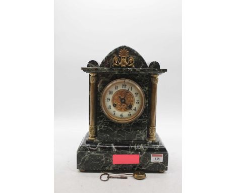 A late Victorian marble cased mantel clock of architectural form, having an enamelled chapter ring with Arabic numerals, flan