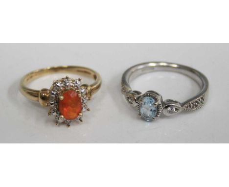 A contemporary 9ct white gold, aquamarine and cz set dress ring, size N; together with a modern 10ct yellow gold orange stone