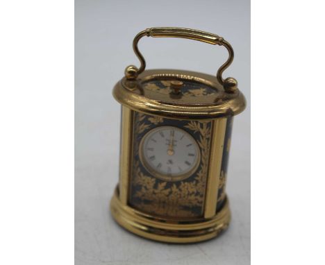 A Halcyon Days enamel decorated miniature carriage clock, h.6.5cm (handle down)