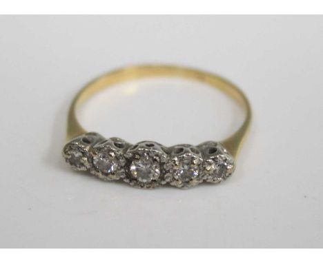 An 18ct yellow gold diamond five stone ring, the graduated round cuts being illusion set, the largest weighing approx 0.1 car