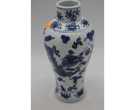 A Chinese blue and white porcelain vase, of baluster form, decorated with dragons chasing a pearl, apocryphal double ring mar