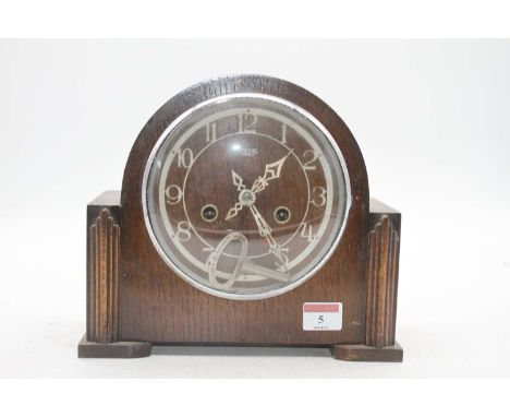 A 1950s Smiths oak cased mantel clock having plastic chapter ring with Arabic numerals and eight day movement, height 22cm