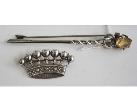 A continental white metal pin brooch in the form of a crown, stamped 900, w.37mm; together with a Celtic influenced white met