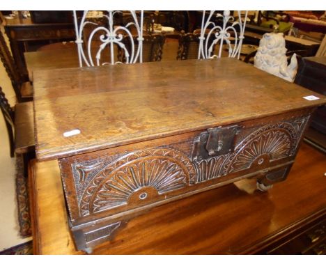A carved oak Bible box in the 17th Century style with lunette carved front panel and bracket feet on later castors