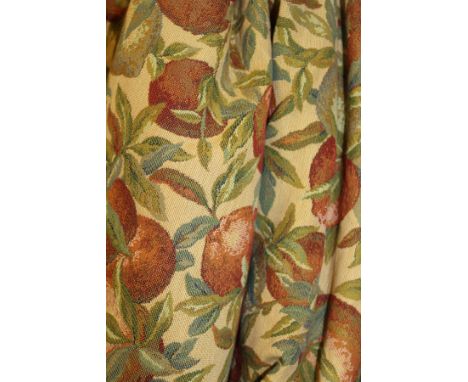 A pair of interlined curtains, the cream ground with fruit and foliate decoration, together with matching pelmet and tie back