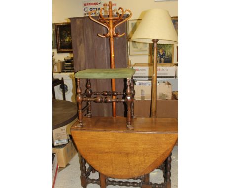 An oak gate-leg table with bobbin-turned supports, together with a circa 1900 stained beech stool with turned supports, a mah