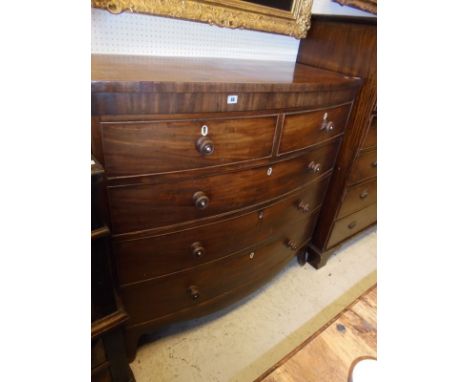 An early Victorian mahogany bow-fronted chest of two short over three long graduated drawers with knob handles to splayed bra