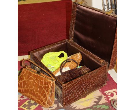 An early 20th Century crocodile skin covered suitcase stamped "Harrods ? London", together with a vintage handbag and a simil