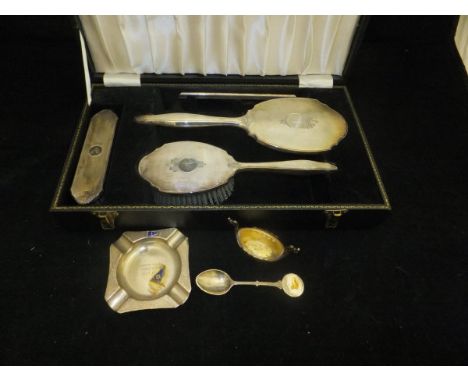 A mid 20th Century cased silver backed dressing table set comprising hand mirror, two brushes and comb, each with engine turn