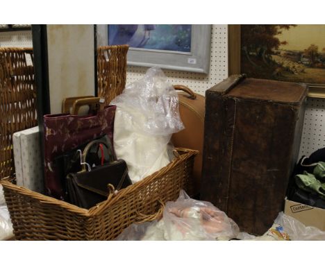 A collection of items to include a wicker hamper containing assorted linen, leather gloves, a snakeskin handbag and a patent 