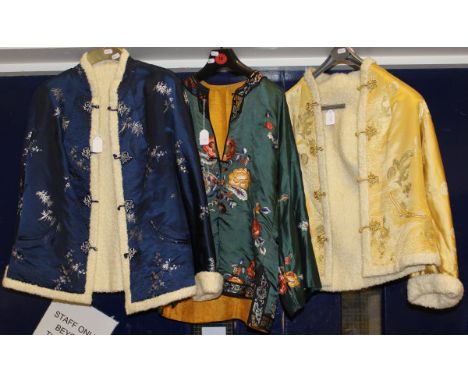 A Chinese silk jacket, the green ground set with floral sprays and border, together with two further Chinese silk jackets, bo