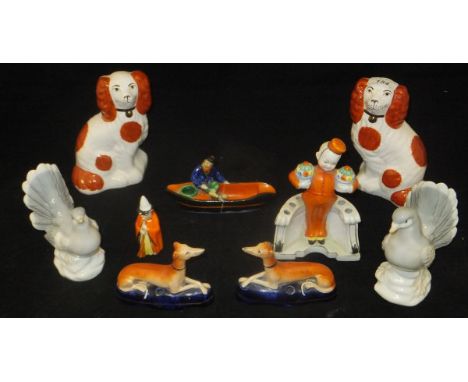 A circa 1920 German biscuit fired porcelain posy vase or hat pin holder as a bell hop with flowers, a Contniental porcelain p