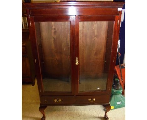 A 19th Century mahogany display cabinet, the two glazed doors enclosing shelves on a base of two drawers, raised on cabriole 