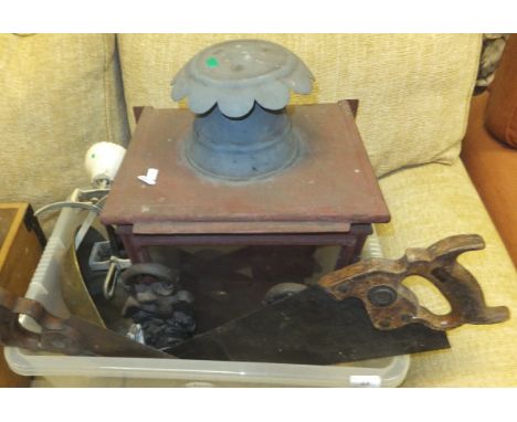 A box containing various metal wares including exterior lantern, cast iron door stops, two saws, a tuck box of various tools,