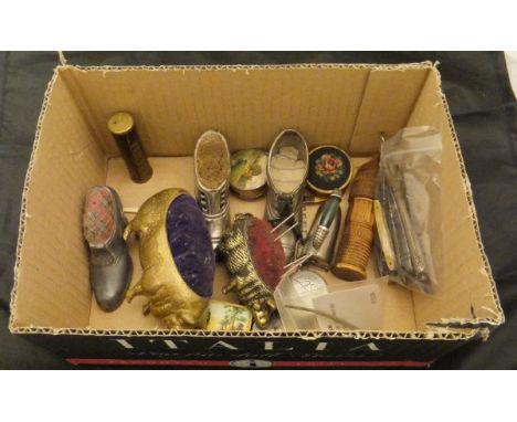 A collection of assorted pin cushions of novelty form to include pigs and shoes together with assorted ear scoops, novelty ta