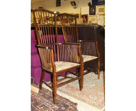 A pair of circa 1900 stained beech stick back elbow chairs