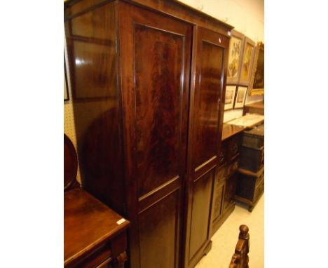 A Victorian figured mahogany two-door wardrobe on bracket feet