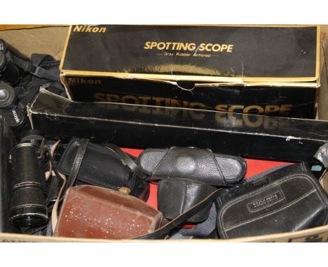 A box containing various cameras and optical equipment, a boxed microscope, etc