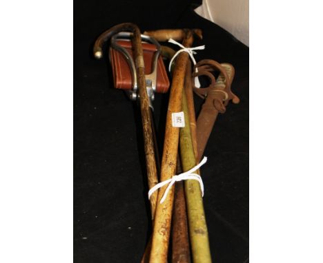 A military sword with shagreen handle, a "Game Bird" shooting stick and five various walking sticks CONDITION REPORTS Length 