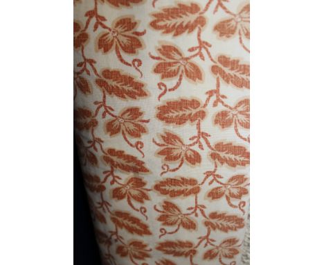 A pair of Osborne & Little "Leaf" pattern cotton interlined curtains, the cream ground with rust leaf design decoration, toge