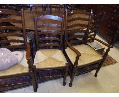 A set of fourteen oak rush-seat ladder back dining chairs in the 17th Century style (twelve plus two carvers)