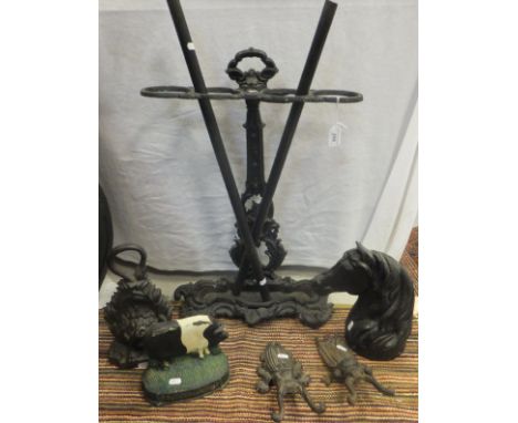 A Victorian style cast iron stick stand, wrought iron fire basket, pair of fire dogs, pair of beetle boot jacks, horse head, 