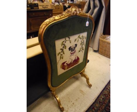 A late Victorian carved giltwood framed fire screen in the Louis XV taste, decorated with a later needlework study of a pug s
