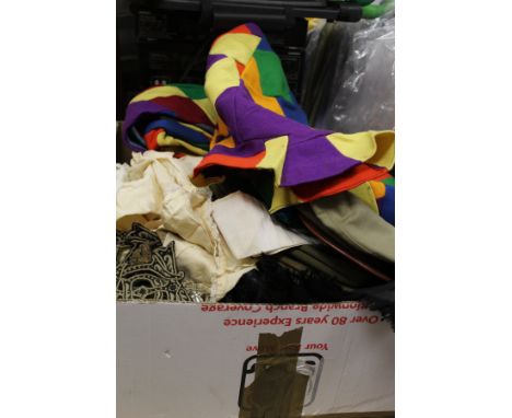 A box of assorted textiles to include a vintage felt harlequin costume, various military caps to include Royal Fusiliers, etc