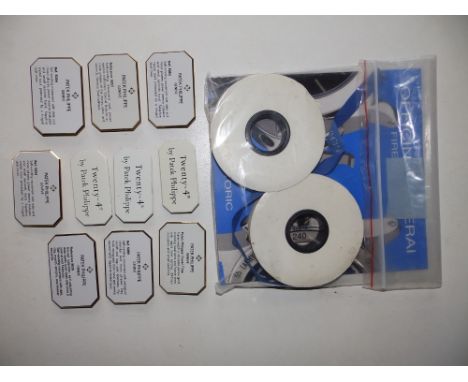 10 Patek Philippe enamelled display stands, approx. 2.75" across, a Panerai catalogue and Panerai promotional dealer ribbons.